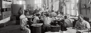 A group of craftsman in the old work factory of Georg Jensen in black and white.