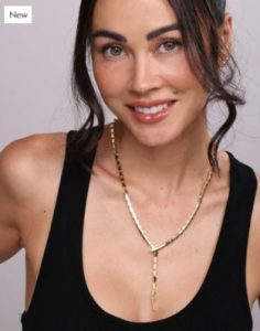 Smiling lady in black tank top wearing new 19 inches long Serpent Lariat Necklace in gold.